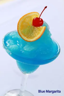 a blue margarita with an orange slice and a cherry at The Lokha Legian Resort & Spa in Legian