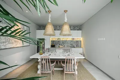 a kitchen with a table and two chairs at Casamaya Villa in Legian