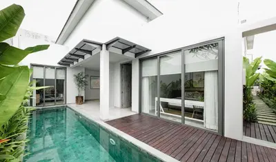an external view of a house with a pool at Casamaya Villa in Legian