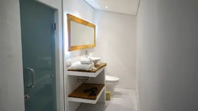 a bathroom with a sink and a mirror and a toilet at PROMO! Private Vacation Rentals Villa, 2 Pools,4 Bedrooms,4 Bathrooms, Bali Seminyak in Seminyak
