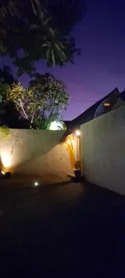 a building with a wall and a tree at night at PROMO! Private Vacation Rentals Villa, 2 Pools,4 Bedrooms,4 Bathrooms, Bali Seminyak in Seminyak