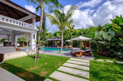 a backyard with a swing and a swimming pool at Villa Eva in Seminyak
