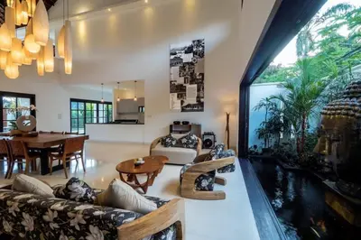 a living room with a large window and a fishtank at Villa Eva in Seminyak