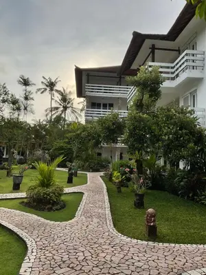 a stone walkway in front of a building at Grand Kumala Hotel - Hotel Kumala Legian Kuta Bali in Legian