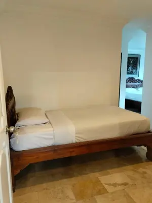 a bed in a small room with at Grand Kumala Hotel - Hotel Kumala Legian Kuta Bali in Legian