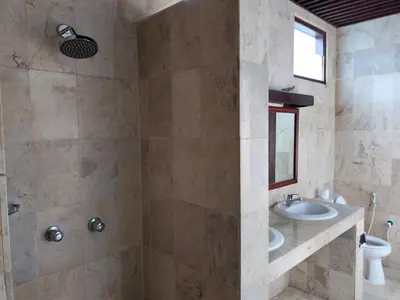 a bathroom with a sink and a shower at Grand Kumala Hotel - Hotel Kumala Legian Kuta Bali in Legian