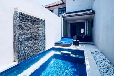 a swimming pool in the middle of a building at Kuta Regency B10 One Bedroom Villa in Kuta