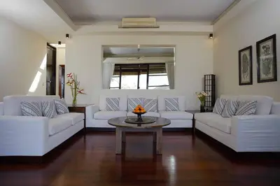 a living room with two white couches and a table at Temple Hill Residence Villa in Jimbaran
