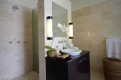a bathroom with a sink and a mirror at Temple Hill Residence Villa in Jimbaran