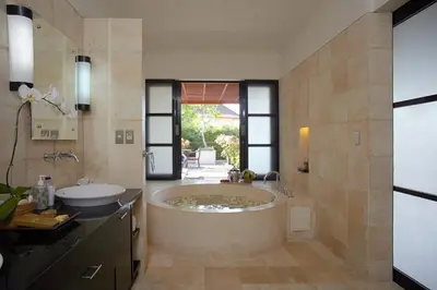 a large bathroom with a tub and a sink at Temple Hill Residence Villa in Jimbaran
