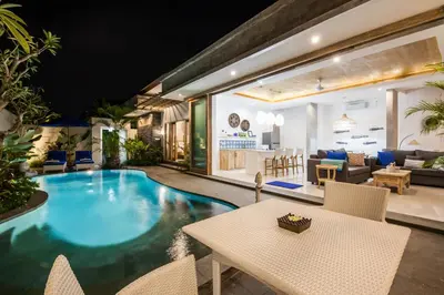 a pool in a living room with a table and chairs at Ambermoon Villa 2 in Seminyak