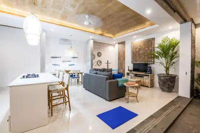 a living room with a couch and a table at Ambermoon Villa 2 in Seminyak