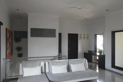 a living room with a couch with pillows at Kedis Bali Villa in Kuta