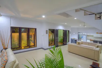 a living room with two couches and a couch at Kedis Bali Villa in Kuta