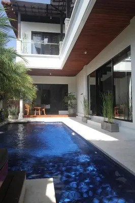 a swimming pool in the backyard of a house at Kedis Bali Villa in Kuta