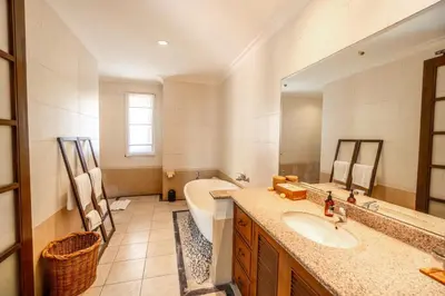 a bathroom with a sink and a tub and a toilet at Kecapi Villa Seminyak by Ini Vie Hospitality in Seminyak