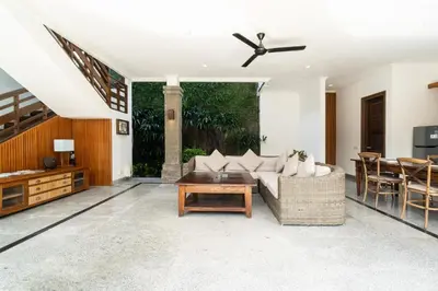 a living room with a couch and a table at Kecapi Villa Seminyak by Ini Vie Hospitality in Seminyak