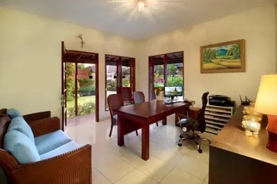 a living room with a desk and a table and chairs at Kecapi Villa Seminyak by Ini Vie Hospitality in Seminyak
