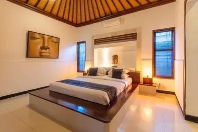 a bedroom with a large bed in a room at Villa Dewata 3 in Seminyak