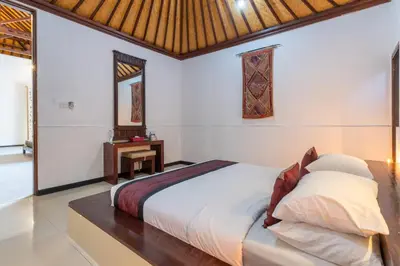 a bedroom with a large bed in a room at Villa Dewata 3 in Seminyak