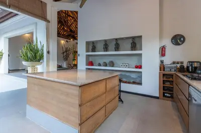a kitchen with a wooden island in a room at Villa Dewata 3 in Seminyak