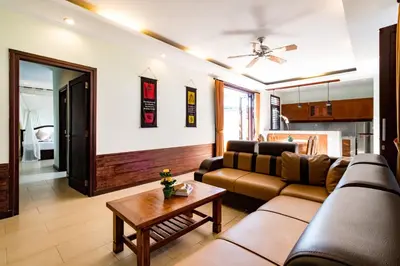 a living room with a couch and a table at Villa Chandraika - 3BR Private Pool Villa by AGATA in Seminyak