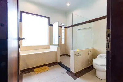 a bathroom with a tub and a toilet and a shower at Villa Chandraika - 3BR Private Pool Villa by AGATA in Seminyak
