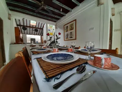 a dining room table with a blue and white plate at Villa Coconut Bali in Seminyak