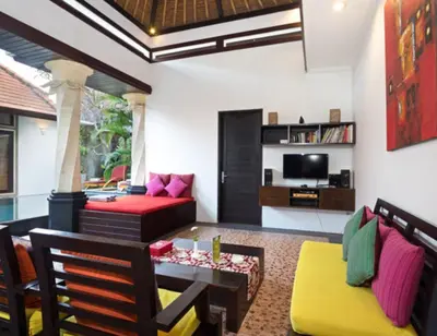 a living room with a couch and a table at Villa Cantik Tresna in Seminyak