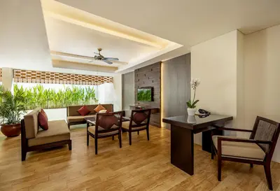 a living room with a dining table and chairs at Villa Kayu Raja in Seminyak
