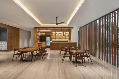 a dining room with wooden tables and chairs at Fairfield by Marriott Bali Kuta Ngurah Rai in Kuta