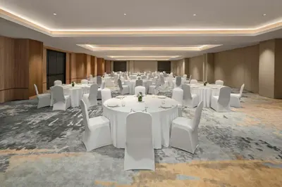 a conference room with white tables and white chairs at Fairfield by Marriott Bali Kuta Ngurah Rai in Kuta