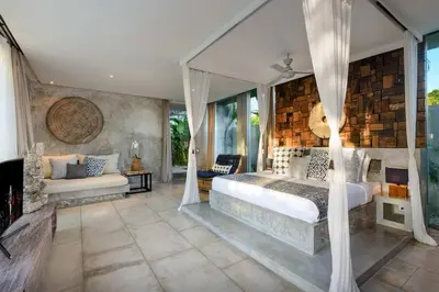 a bedroom with a bed and a couch at Lavish 5 Bed, Sleeps 10, Butler, Daily Breakfast in Canggu