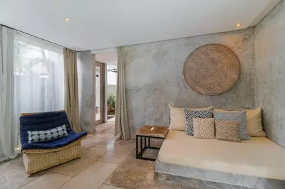 a living room with a couch and a chair at Lavish 5 Bed, Sleeps 10, Butler, Daily Breakfast in Canggu