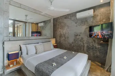 a bedroom with a white bed and a tv at Lavish 5 Bed, Sleeps 10, Butler, Daily Breakfast in Canggu