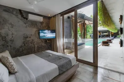 a bedroom with a large bed and a swimming pool at Lavish 5 Bed, Sleeps 10, Butler, Daily Breakfast in Canggu