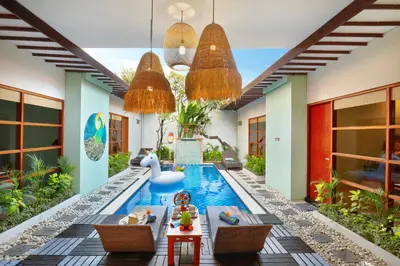 a pool in a house with a swan in the middle at The Vie Villa Legian in Legian