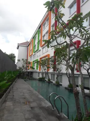 a swimming pool in front of a building at Zuri Express Jimbaran in Jimbaran