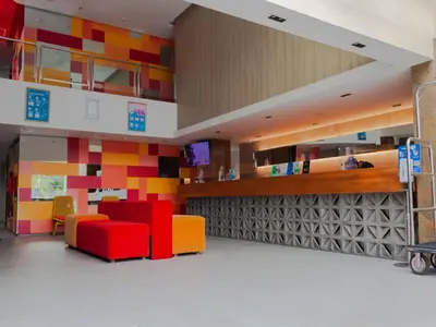 a room with colorful furniture and a wall of squares at Zuri Express Jimbaran in Jimbaran