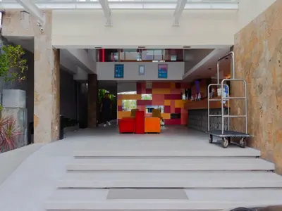 an empty hallway with colorful furniture in a building at Zuri Express Jimbaran in Jimbaran