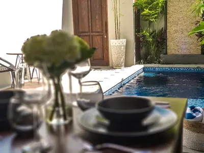a table with a plate of food and a cup of coffee at Villa Pulau Rumah in Seminyak