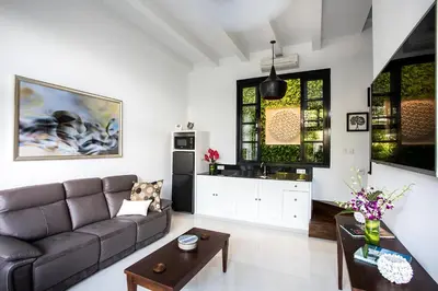 a living room with a couch and a table at Villa Pulau Rumah in Seminyak