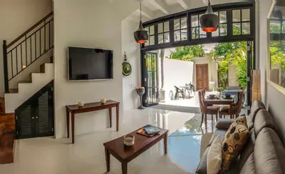 a living room with a couch and a table at Villa Pulau Rumah in Seminyak