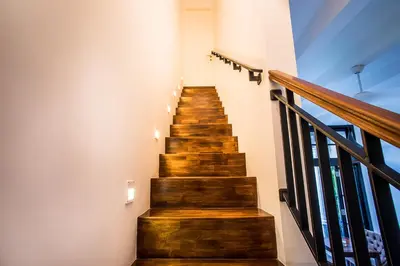 a staircase in a house with wooden steps at Villa Pulau Rumah in Seminyak
