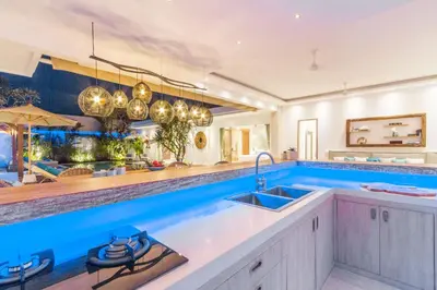 a kitchen with a sink and a large aquarium at Villa Smilla in Seminyak