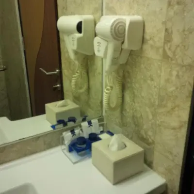a bathroom with a sink and a mirror at Serela Kuta in Kuta