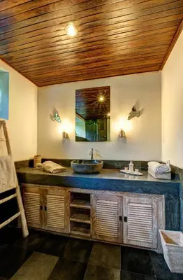 a bathroom with a sink and a mirror at Villa Santi Seminyak in Seminyak