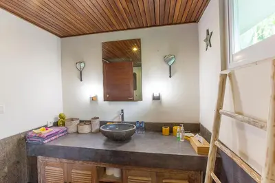 a bathroom with a sink and a mirror at Villa Santi Seminyak in Seminyak