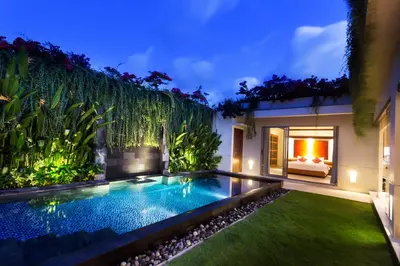 a swimming pool in the backyard of a villa at Villa by the Beach in Jimbaran