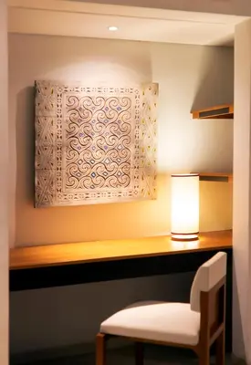 a desk with a chair and a lamp at Villa by the Beach in Jimbaran